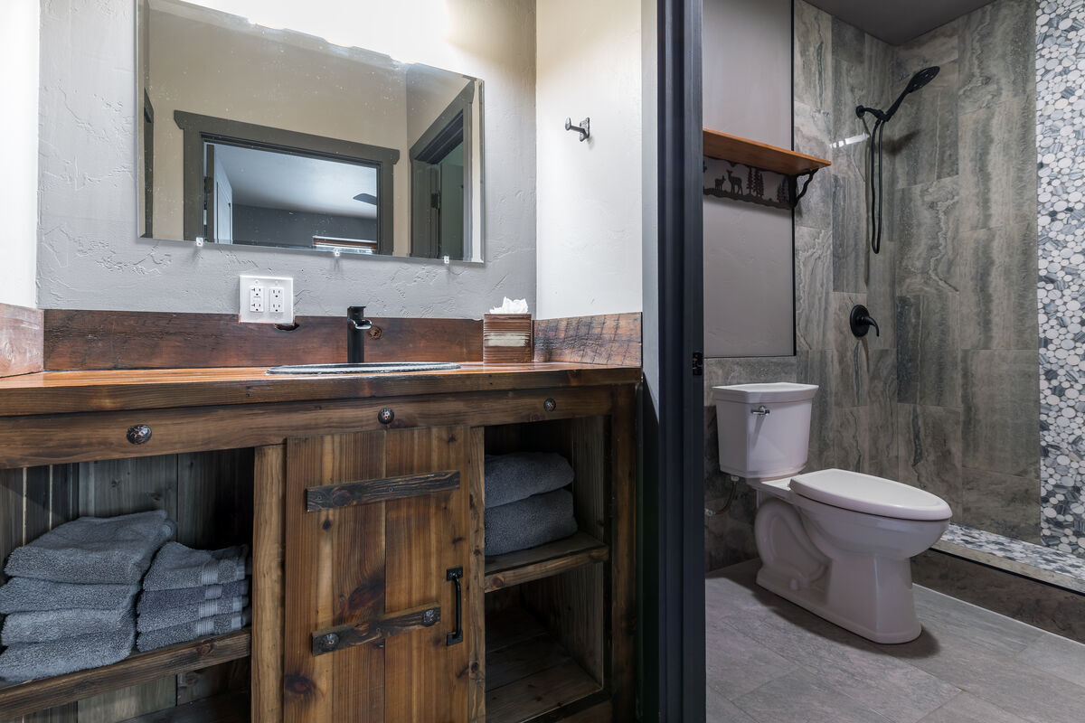 This uniquely designed oversized vanity offers ample storage space, providing a convenient solution for all your travel essentials.  We provide luxurious shower amenities so you don't have to pack them.  A hairdryer is in each bathroom. (Room 2)
