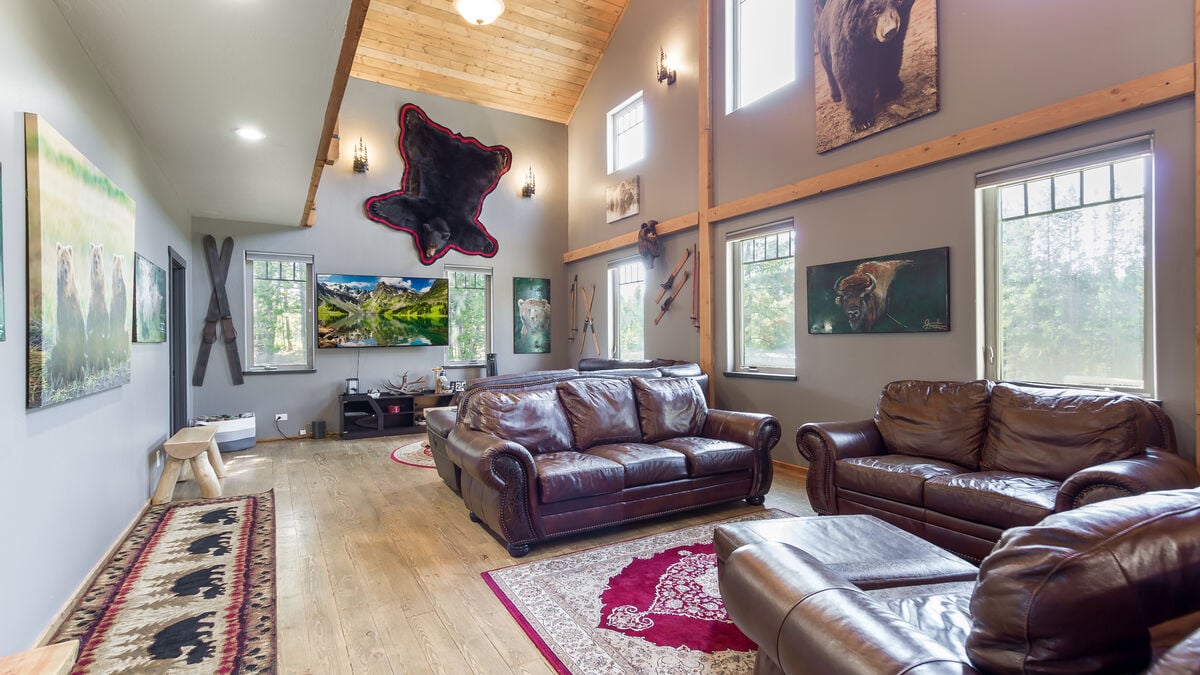 This spacious upstairs living room has multiple sitting areas, a 75