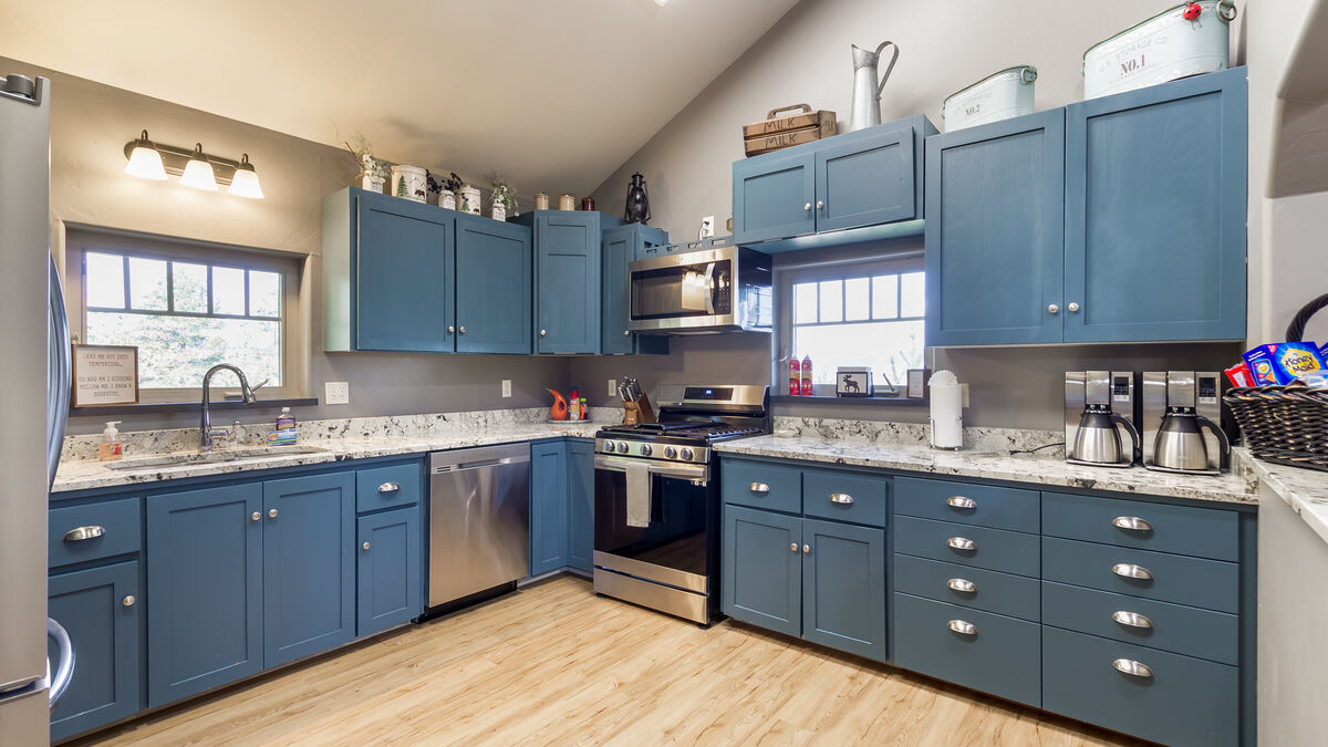 This property's fully equipped and spacious kitchen is a cook's dream come true. You can prepare delicious home-cooked meals with ample counter space and all the necessary cookware and appliances. It is the perfect space for all your culinary needs.