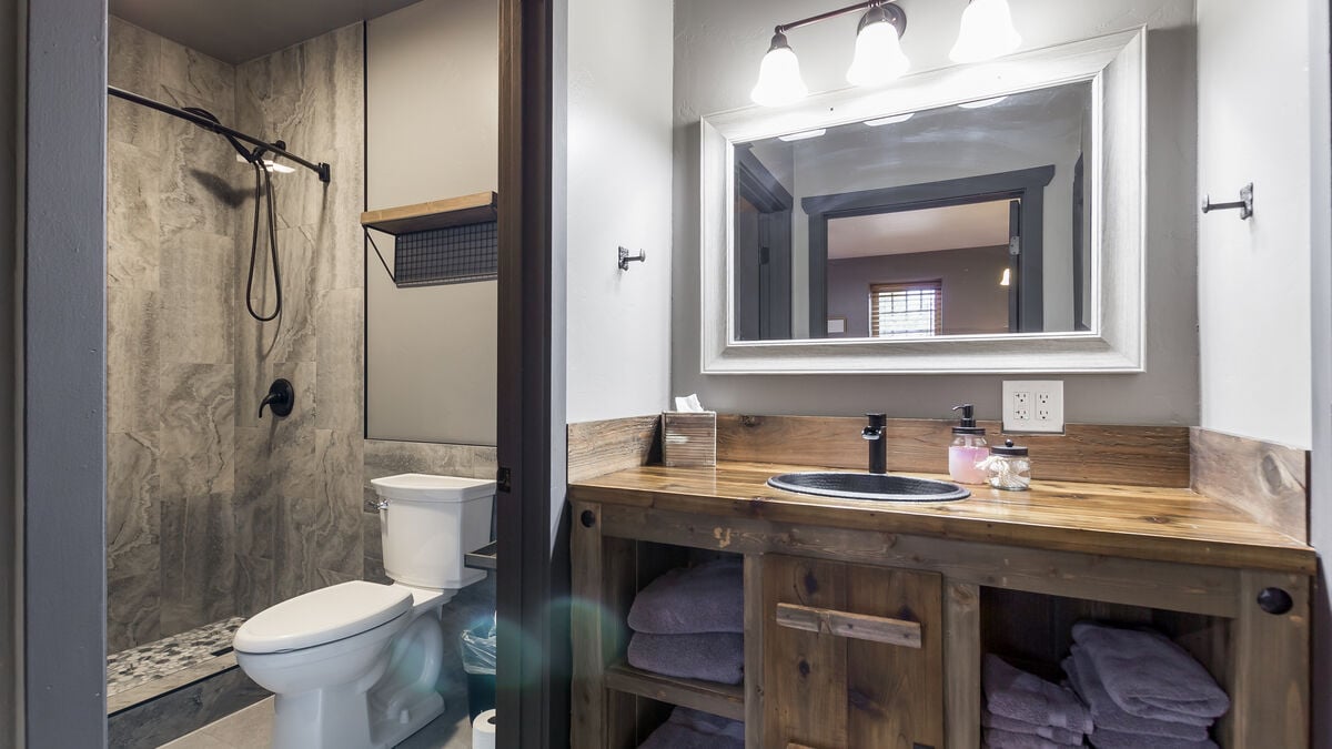This uniquely designed oversized vanity offers ample storage space, providing a convenient solution for all your travel essentials.  We provide luxurious shower amenities so you don't have to pack them.  A hairdryer is in each bathroom. (Room 1)