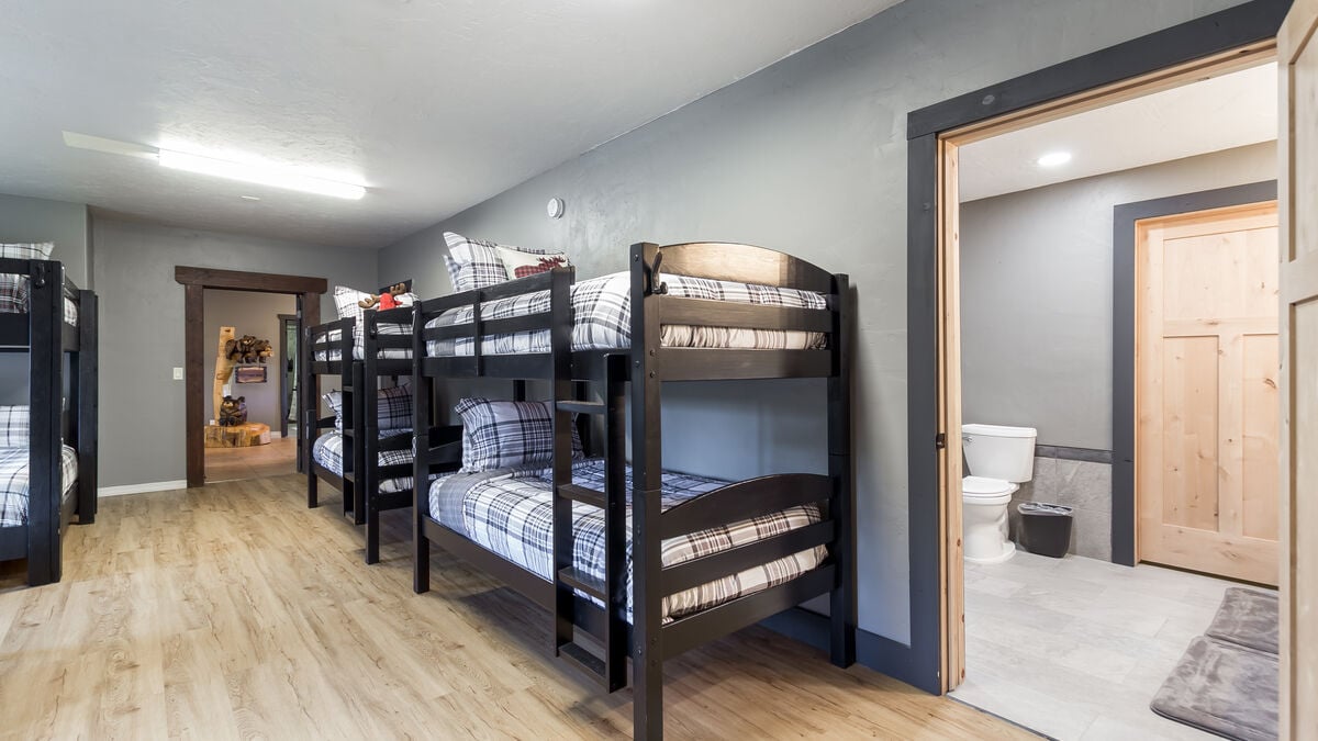 Enjoy our versatile bunk room's comfort, space, and convenience with plenty of hooks for hanging clothes or towels and several luggage racks,  Its comfortable beds and shared bath facilities make this room ideal for a unique accommodation solution.