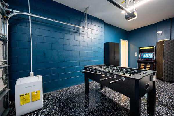 Games room showing  AC , foosball and arcade game