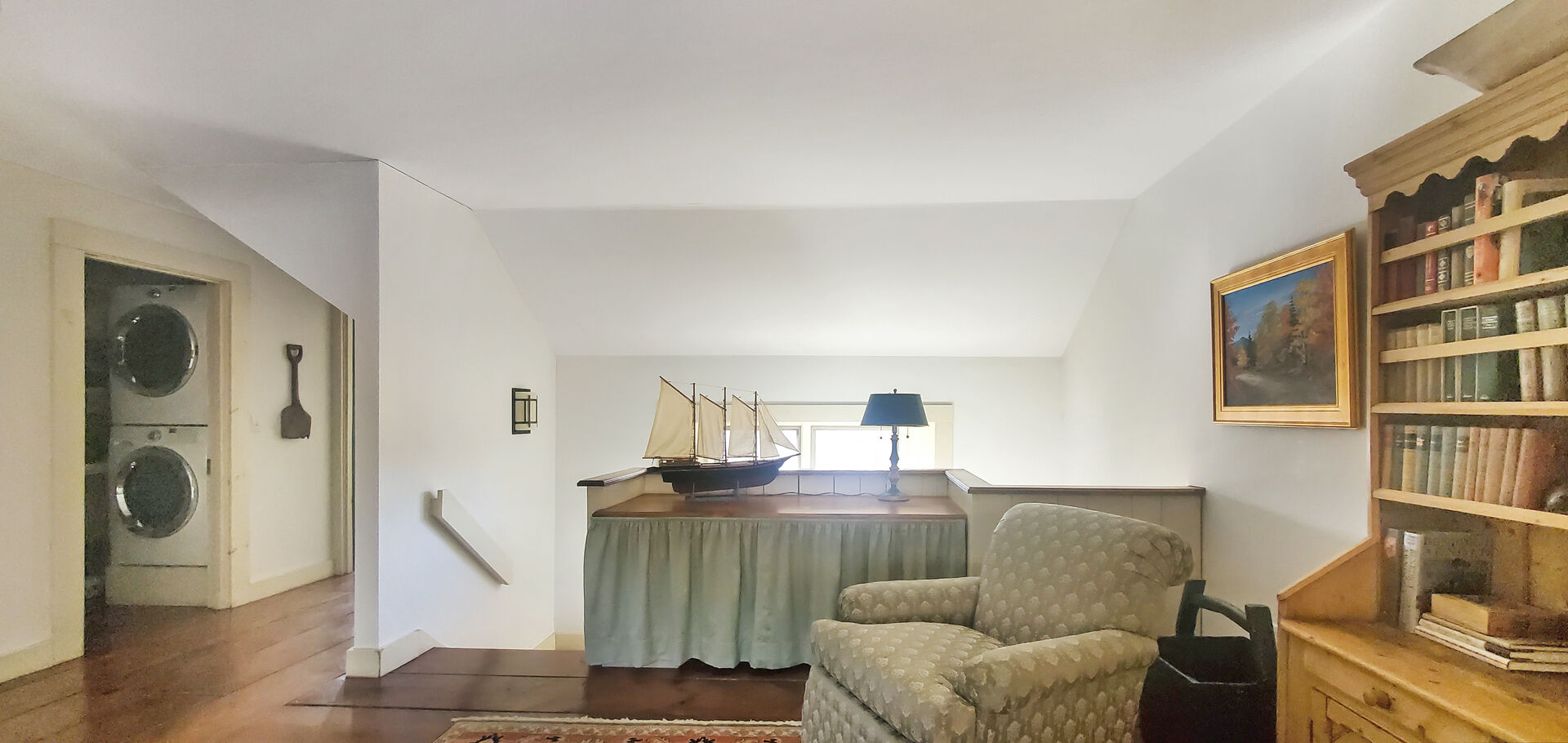 Upper level TV in Small sitting area with a laundry closet