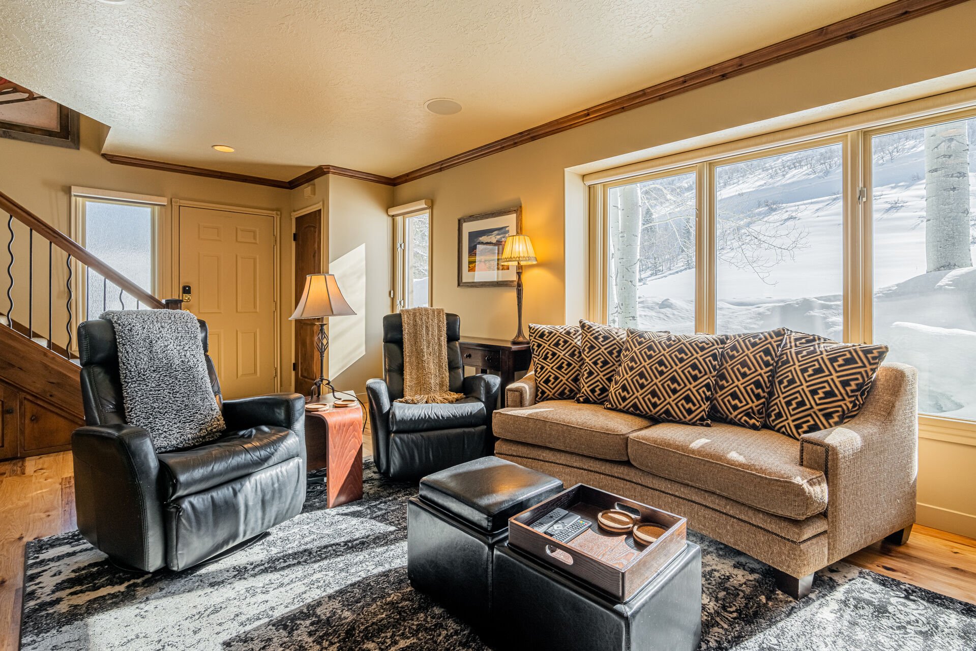 Living Room with plush couch, 2 electric, leather recliners, gas fireplace, and smart TV