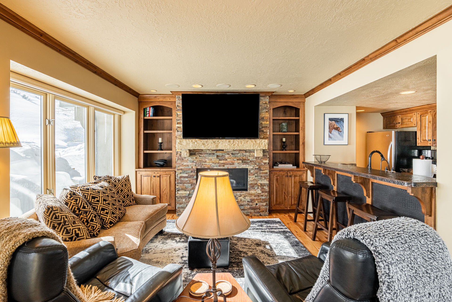 Living Room with plush couch, 2 electric, leather recliners, gas fireplace, and smart TV