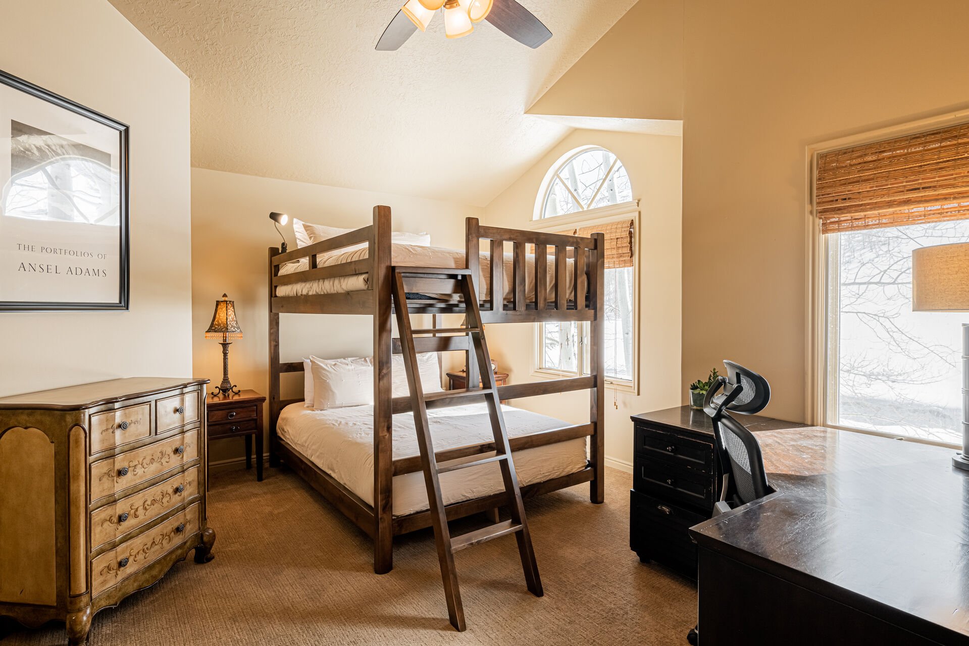 Upper Level Bedroom 2 with queen over queen bunk beds, work desk, TV, and en suite bathroom