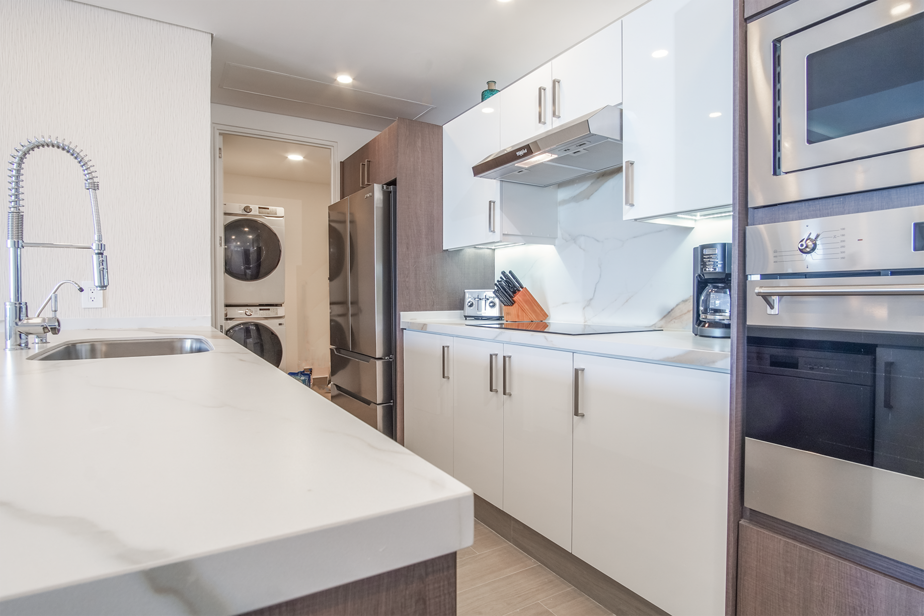 The kitchen attaches to a utility room with its own washer and dryer