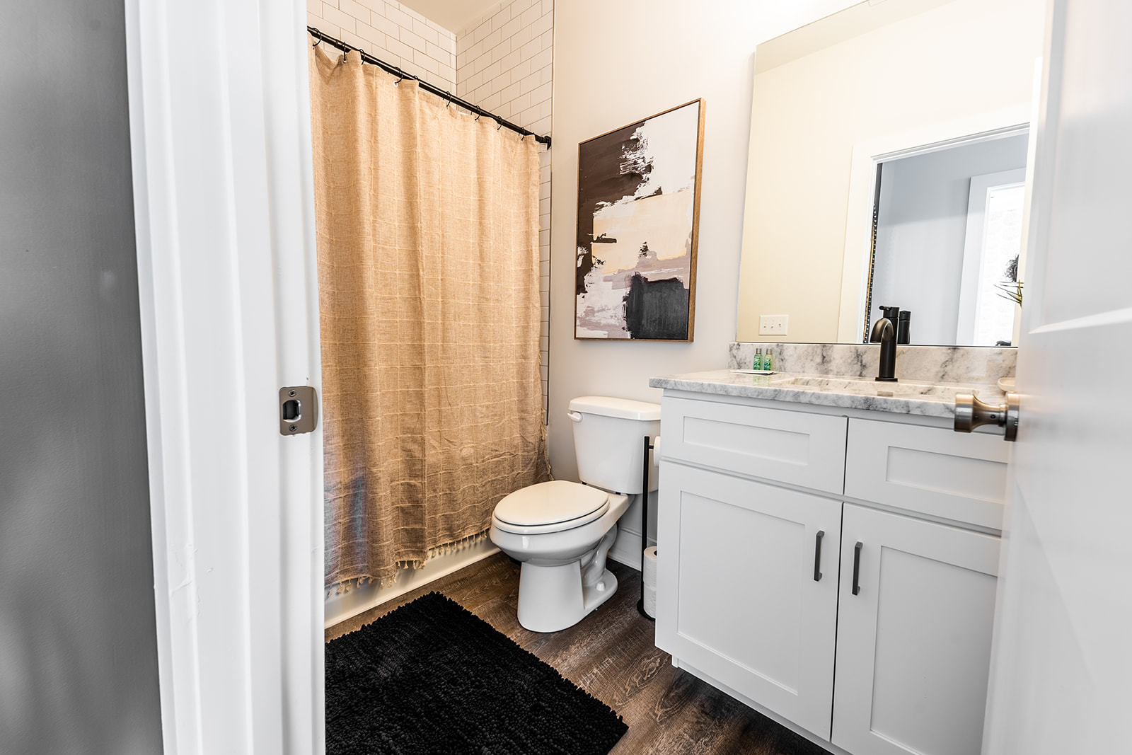 Unit 1: Hallway Full Bathroom featuring Single Vanity and Shower/Tub Combo. (2nd Floor)