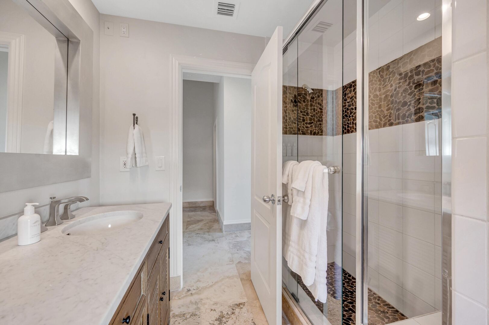 Bathroom with a walk in shower is conveniently located between Bedrooms Four and Five.