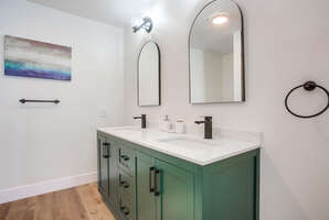 Dual vanity and bright lighting of the in-suite master bathroom