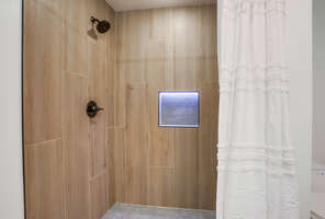 Master bathroom with large walk-in shower (there is a step into the shower)