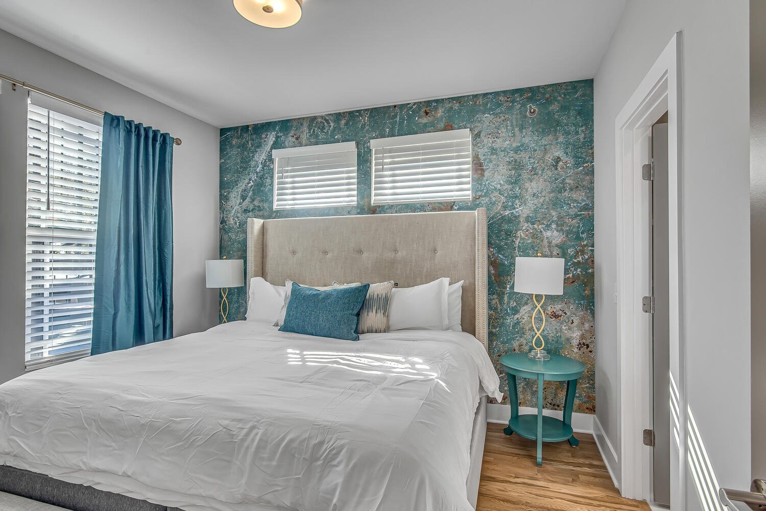 Unit 1: PRIMARY BEDROOM (3rd floor) King bed, large flat screen TV, walk in closet, en-suite master bathroom with large vanity and shower/tub combo.