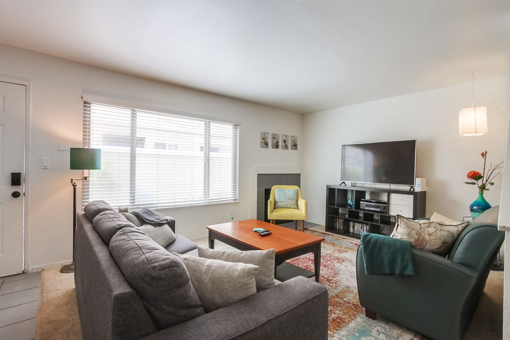Living room with wood-burning fireplace, convertible twin size sofa bed, smart TV with streaming and board games for friends and family to enjoy!