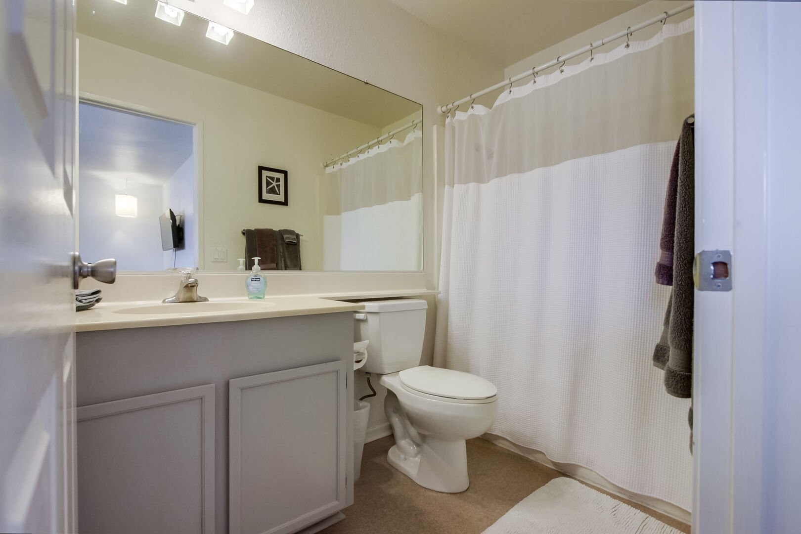 Upper level in-suite master bathroom with shower-tub combo