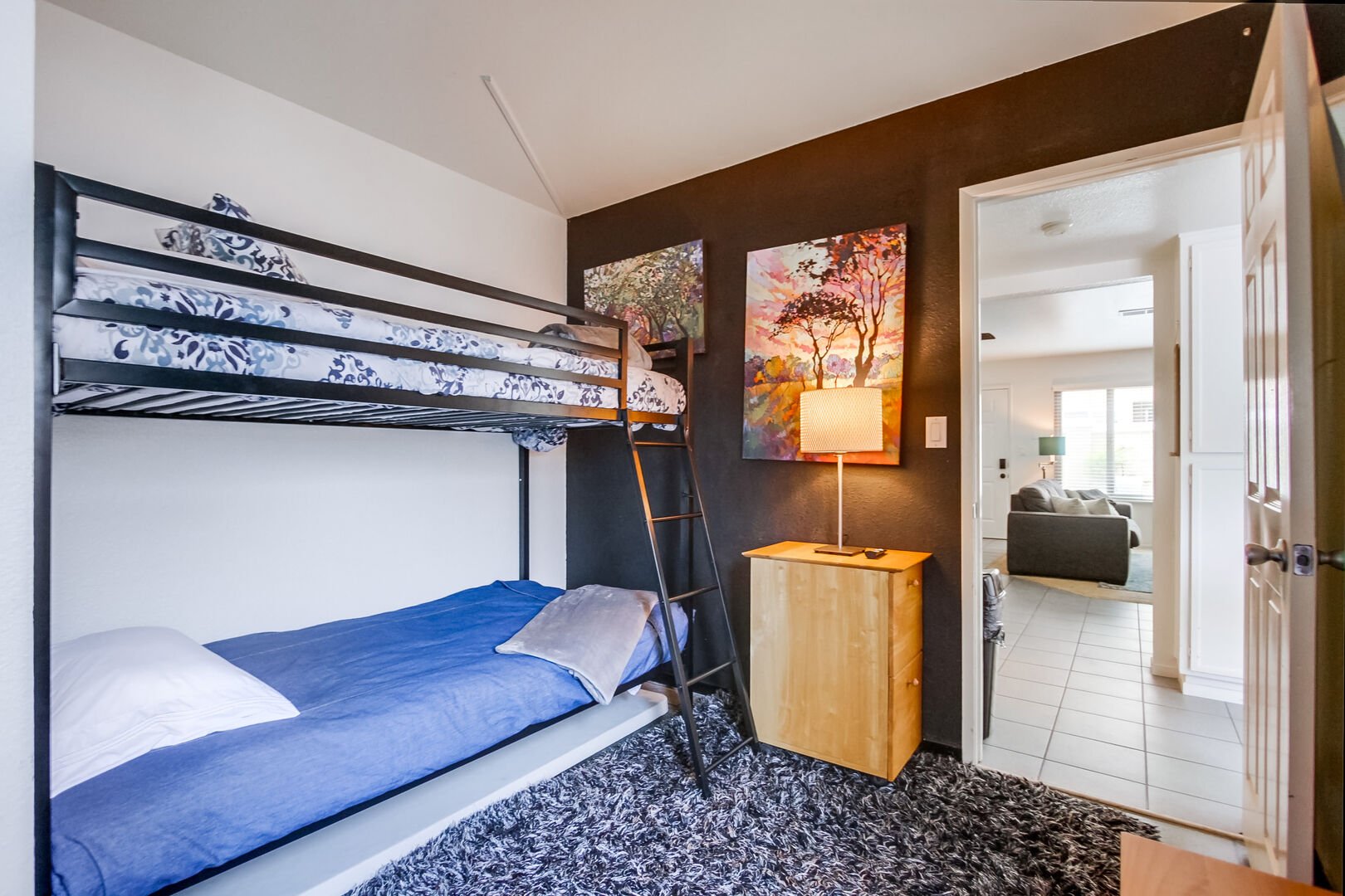 Lower level guest bedroom with bunk bed with twin size beds and smart TV with streaming