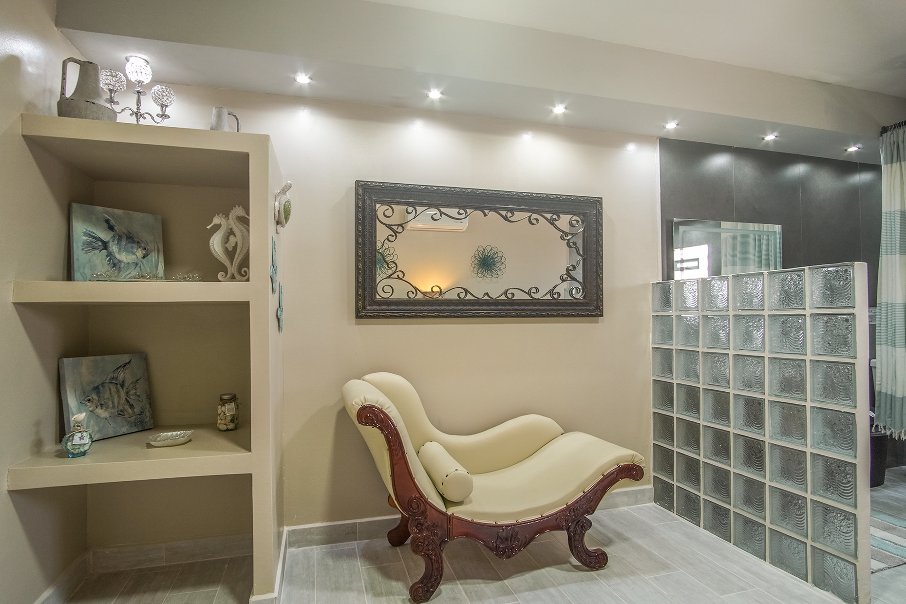 elegant chaise in the master bathroom and glass block wall
