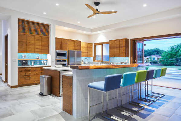 Let's explore the open kitchen at Casa Breeze, strategically designed for convenience and connection.
