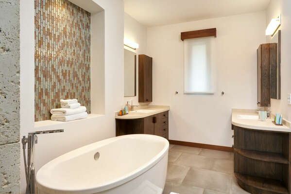 The bathtub adds an extra touch of luxury, inviting you to escape into a world of tranquility.