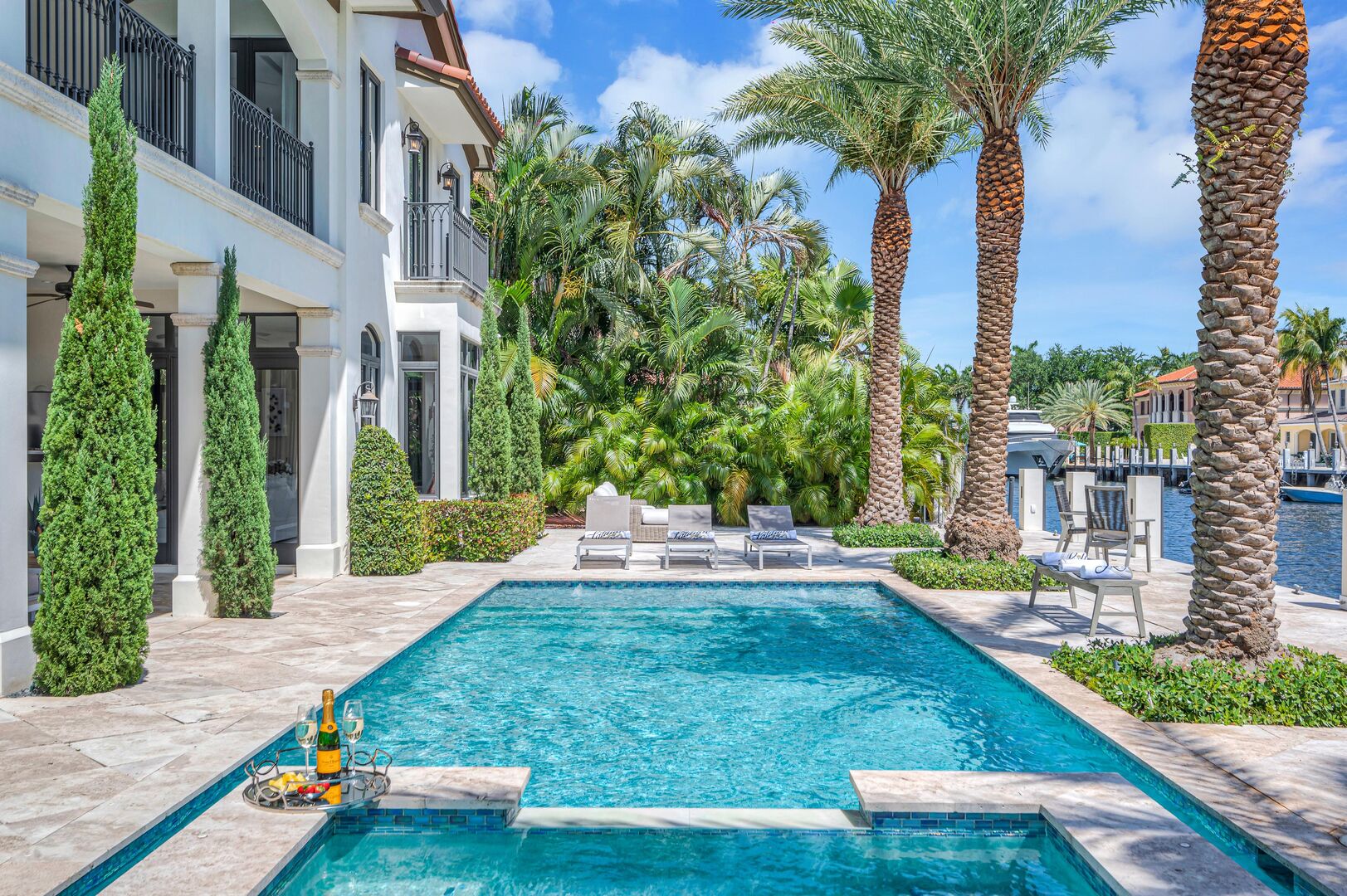 Delight in waterfront tranquility from the heated pool, hot tub and three lounge areas.