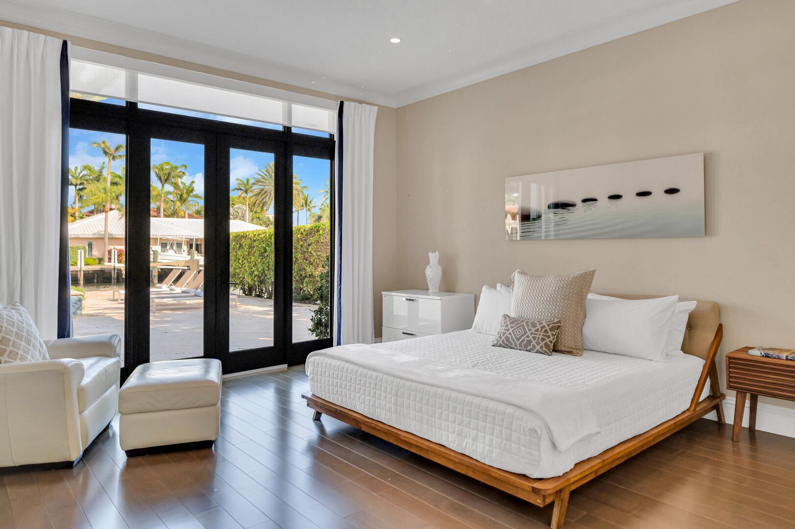 Bedroom six located on the ground flour boasts a king size bed, smart TV and patio access with its heated pool.
