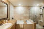 Main level master bedroom 2 en suite bathroom with tub and glass shower