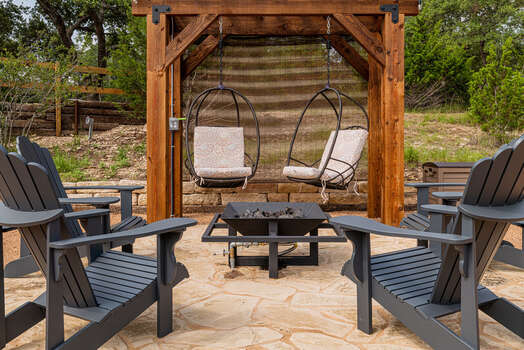 Enjoy the raised fire pit with 4 chairs and two comfortable swings