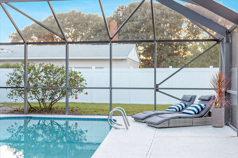 Private screened poolside escape with a cozy lounge area!