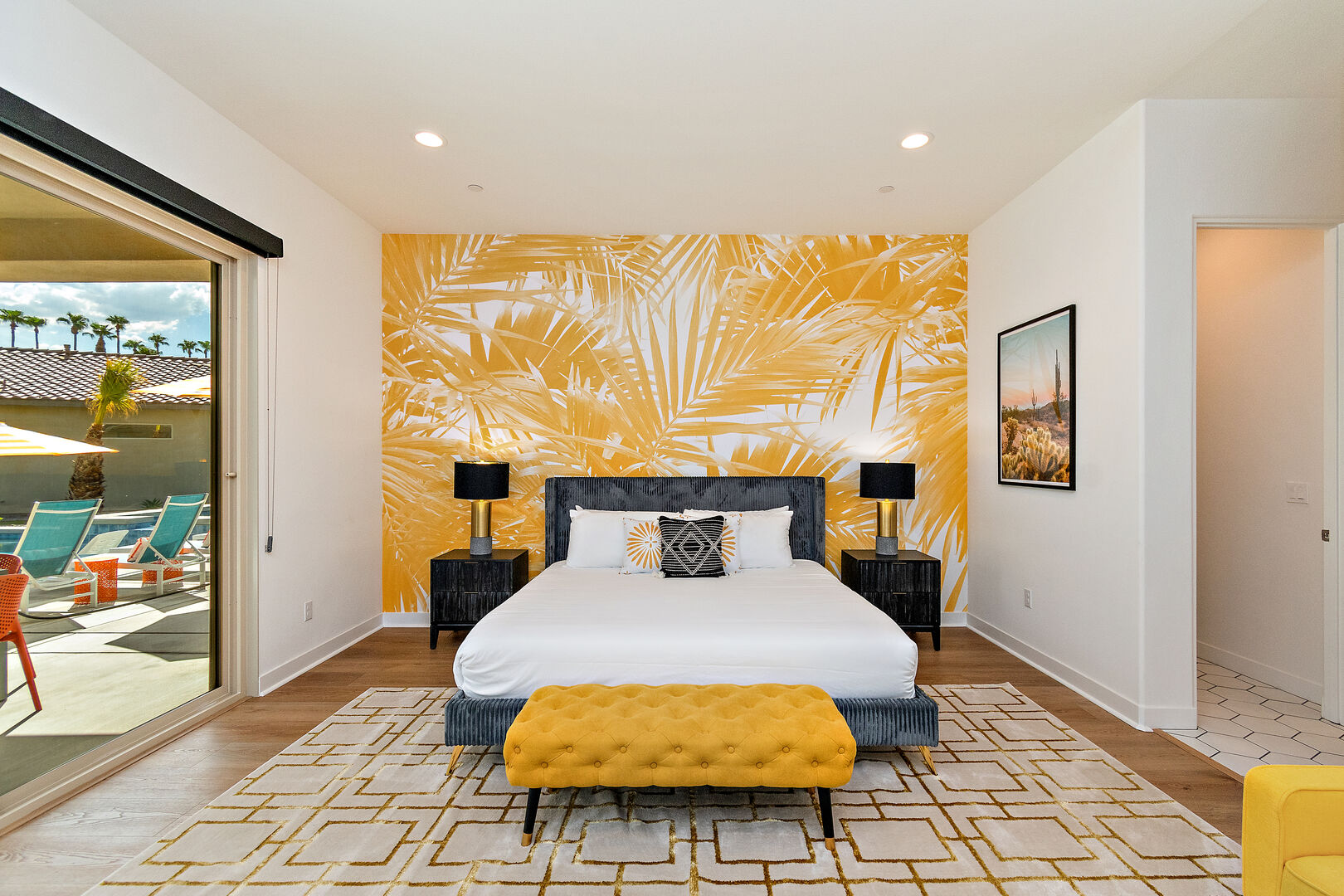 Master Suite 1 is located next to bedroom 2 and features a King-sized Bed with gold accents.