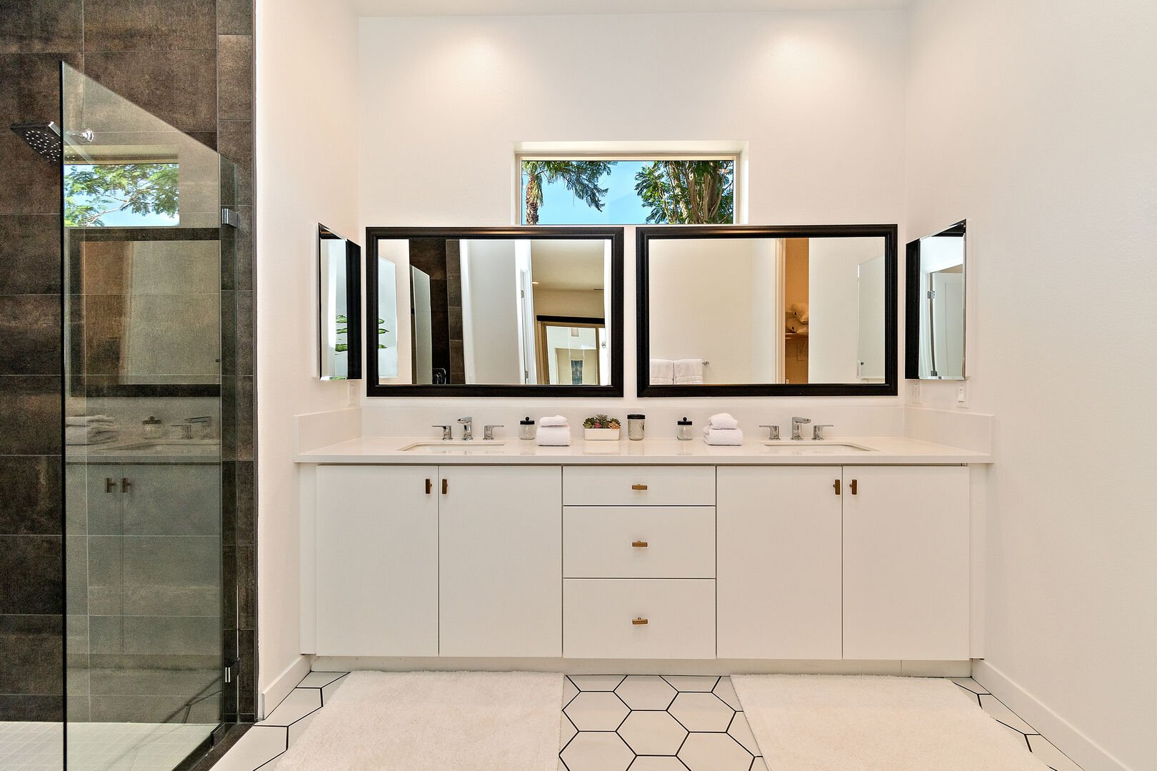 The private en suite bathroom features a tile shower and double vanity sinks.