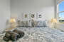 Another fabulous King bedroom with bedside tables & lamps. Gorgeous coastal bird prints adorn the wall.