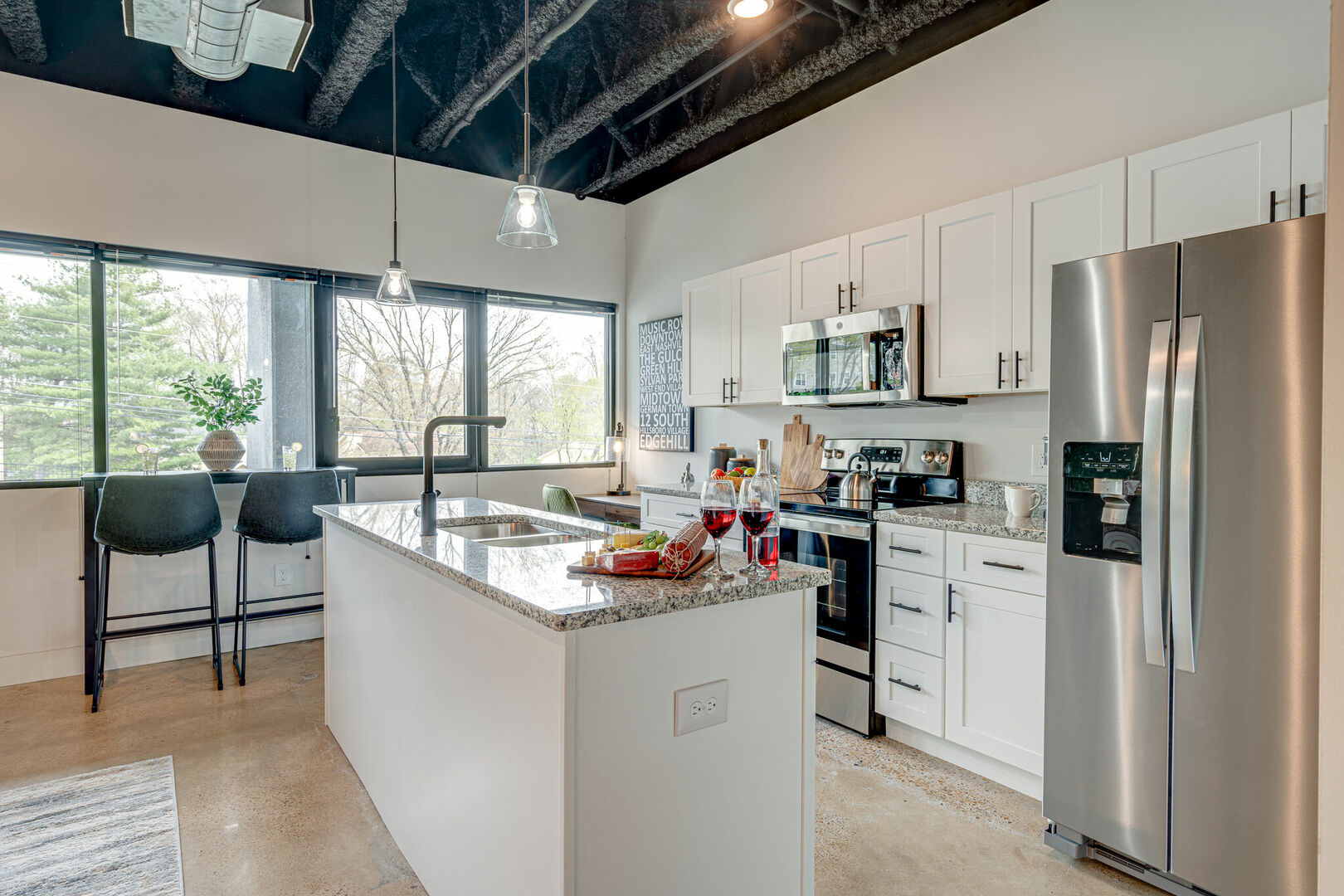 Fully equipped kitchen featuring stocked with basic cooking essentials and stainless steel appliances.