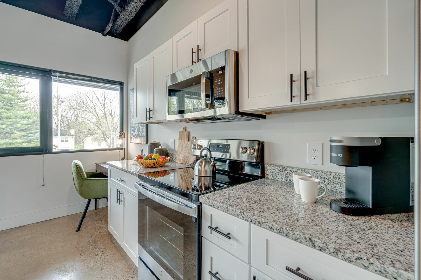 Fully equipped kitchen featuring stocked with basic cooking essentials and stainless steel appliances.