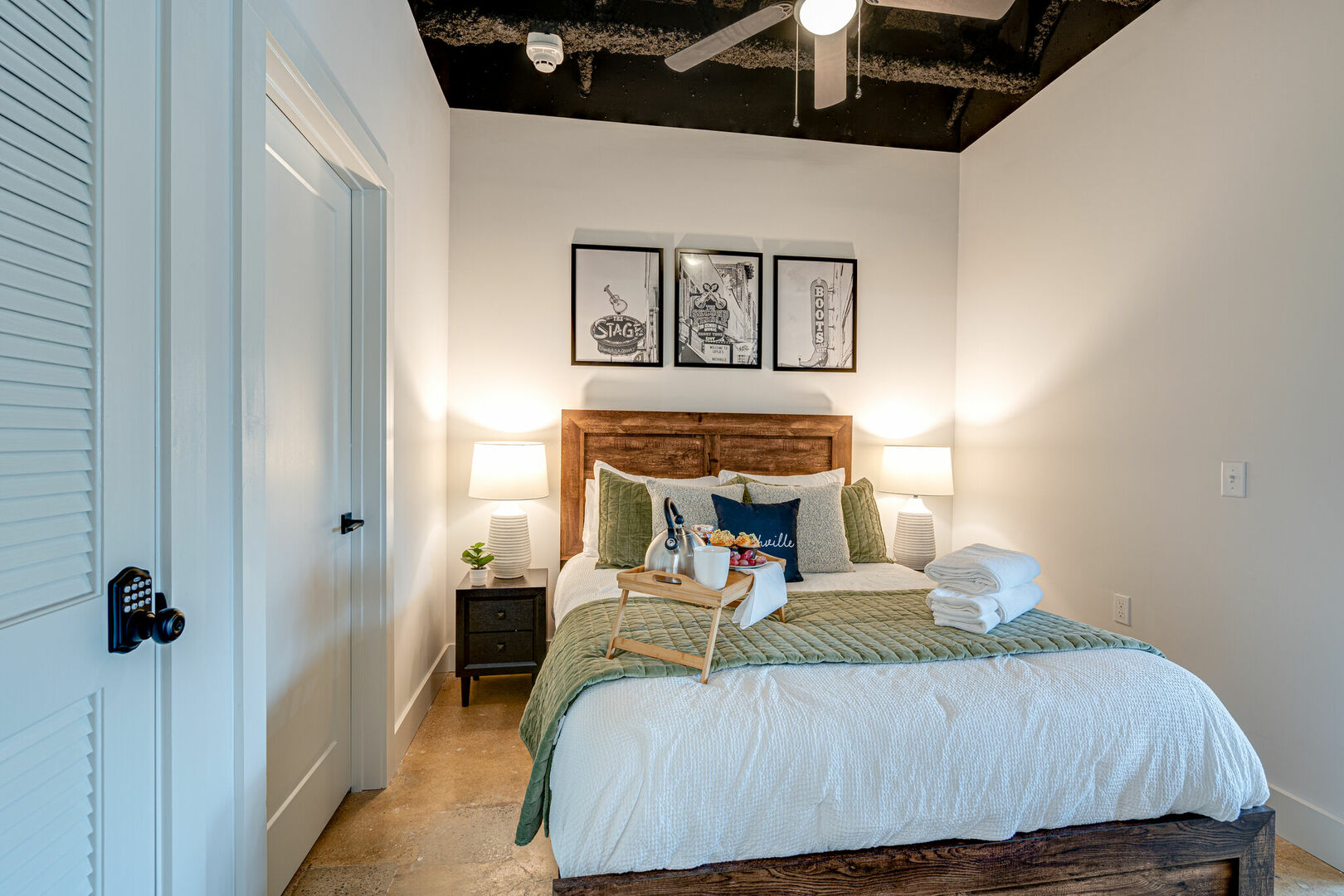 Primary Bedroom featuring a Queen size bed, flat-screen SMART TV and Nashville themed designer furnishings.