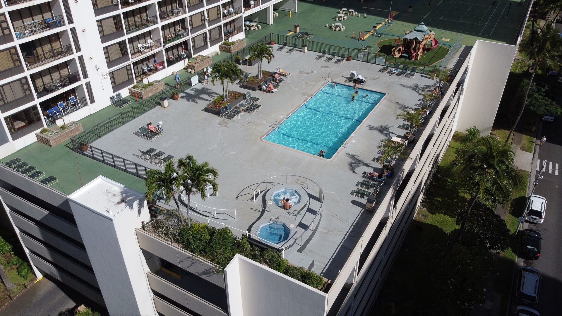 6th floor recreation area complete with pool, hot tub, sun loungers, BBQ area, and playground