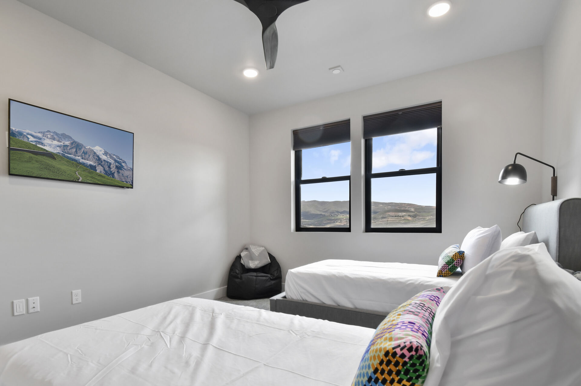 Guest bedroom with dual beds has HDTV with Smart Channels