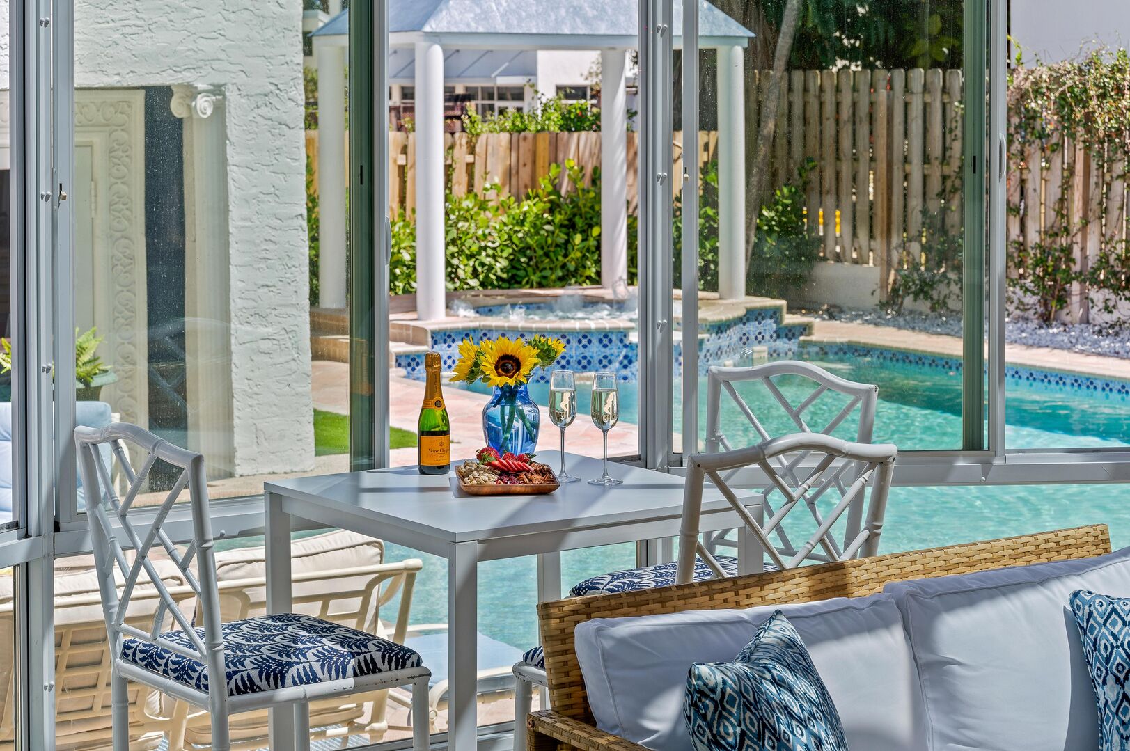 Sunlit Serenity: Where our sunroom's inviting seating beckons you to relax and enjoy poolside paradise.