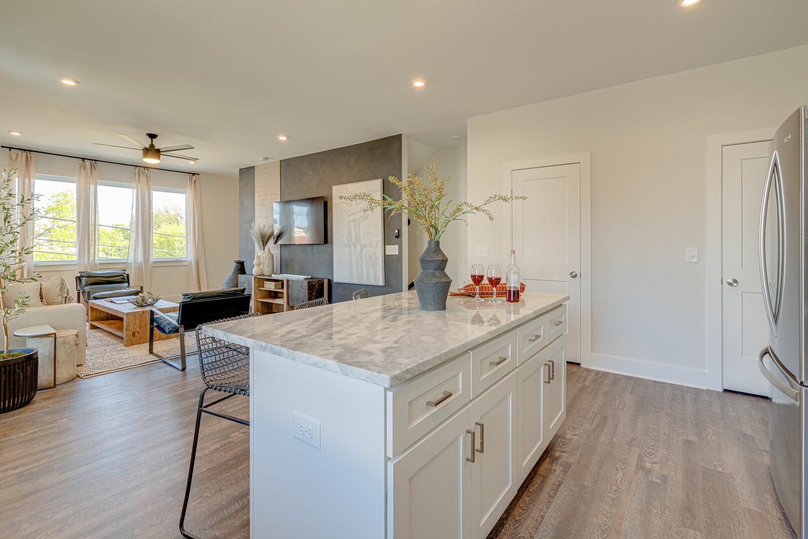 2nd floor: Fully equipped kitchen stocked with basic cooking essentials and stainless steel appliances overlooking the designer furnished living room.