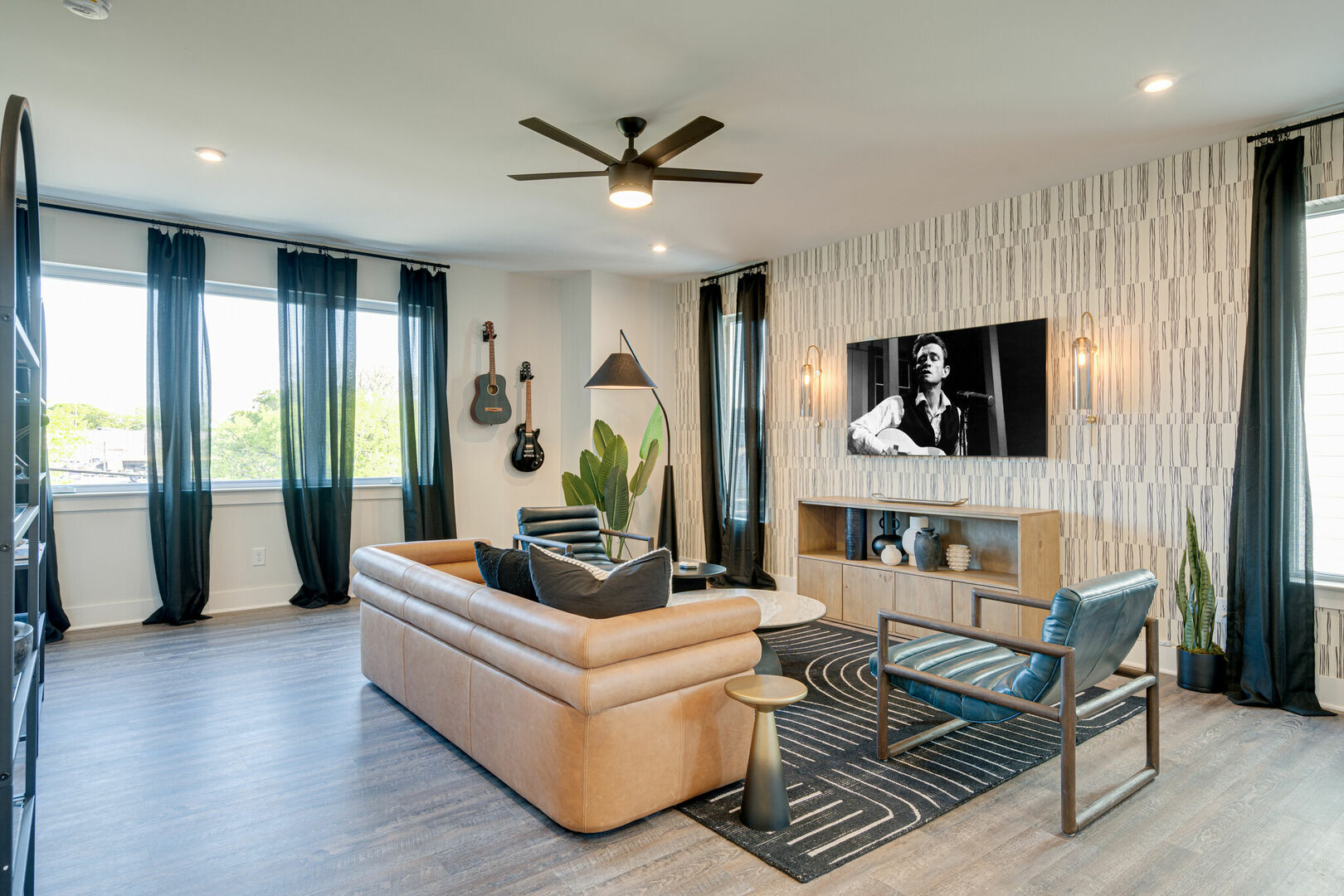 Open concept bring living space featuring a smart flat-screen tv and designer furnishings. (2nd Floor)
