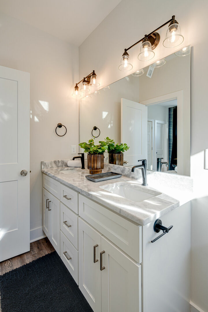 Primary en-suite bathroom with dual vanity and stand-in shower. (3rd Floor)