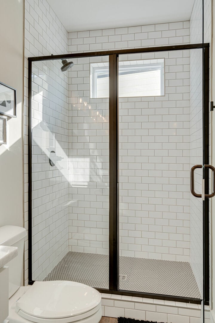 Primary en-suite bathroom with dual vanity and stand-in shower. (3rd Floor)