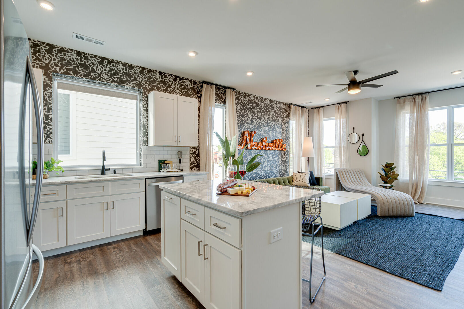 Open kitchen with stainless steel appliances, large island, breakfast bar seating, and is fully equipped with your basic cooking essentials.