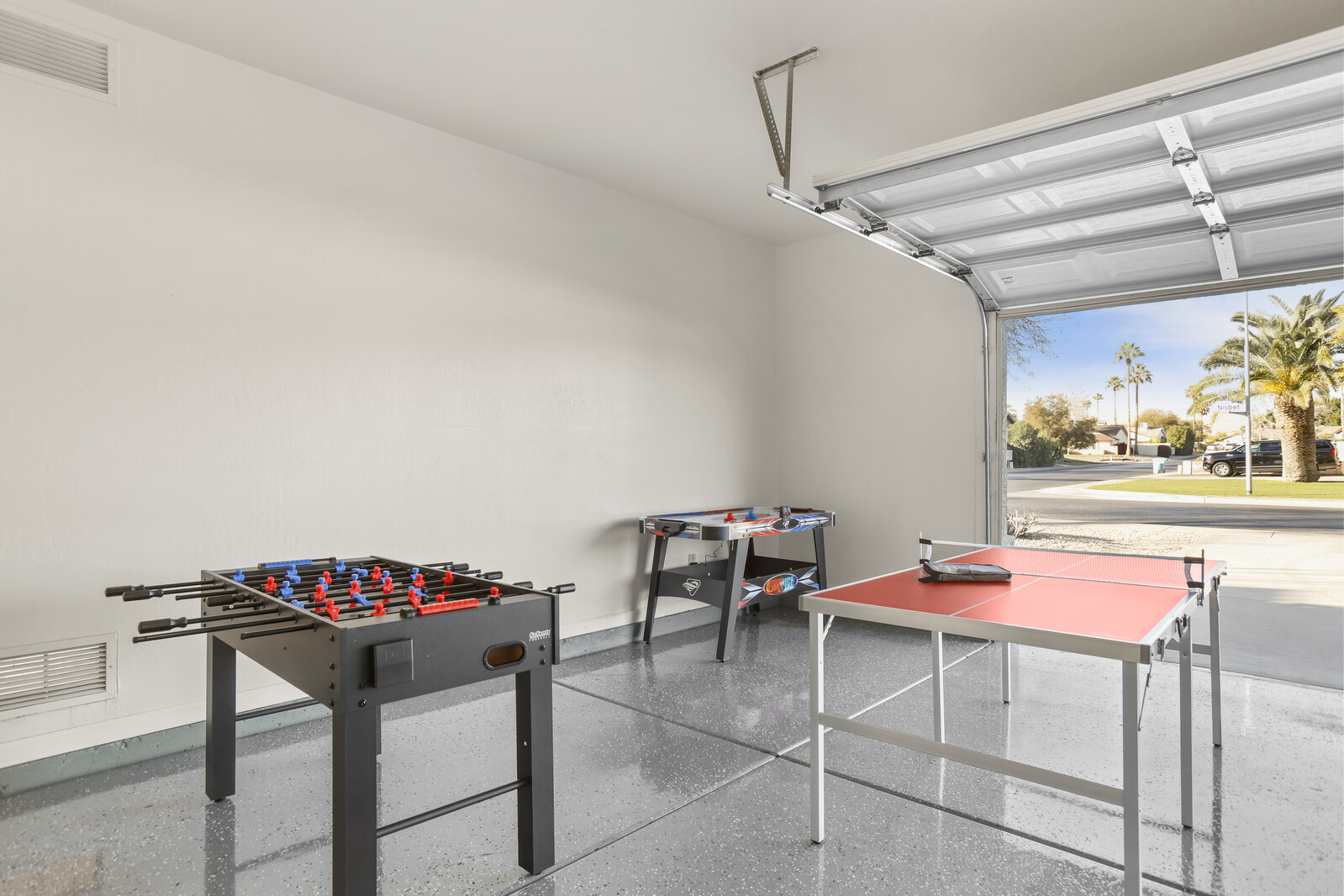 Garage is converted into game room w/ Foosball, Ping Pong Table & Air Hockey
