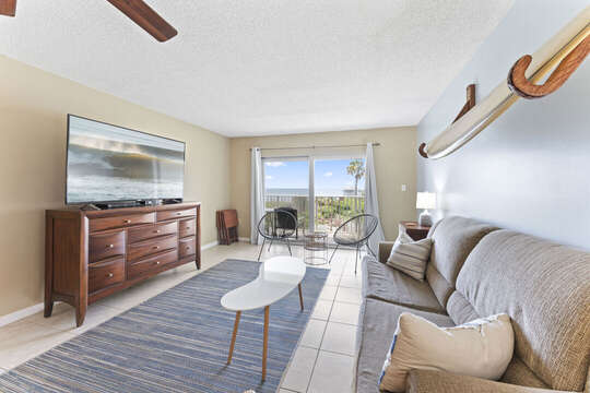 Living room facing out to the balcony and oceanfront view!