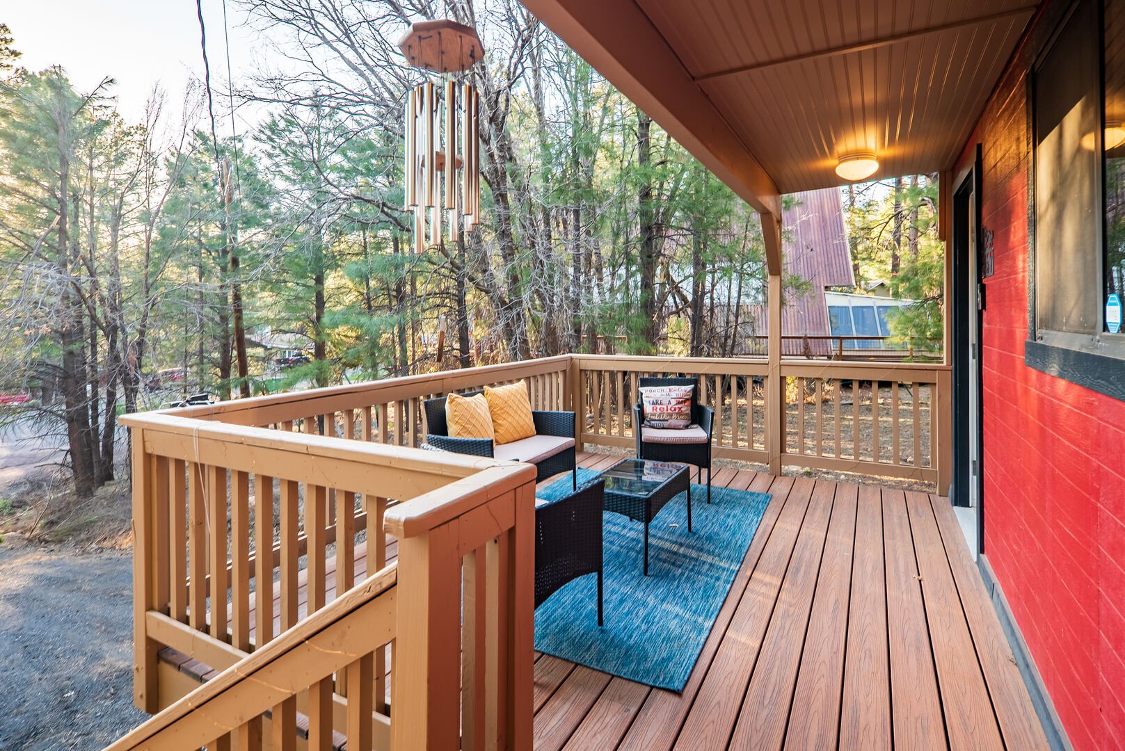 Relax and enjoy nature in the outdoor seating available on the front porch.
