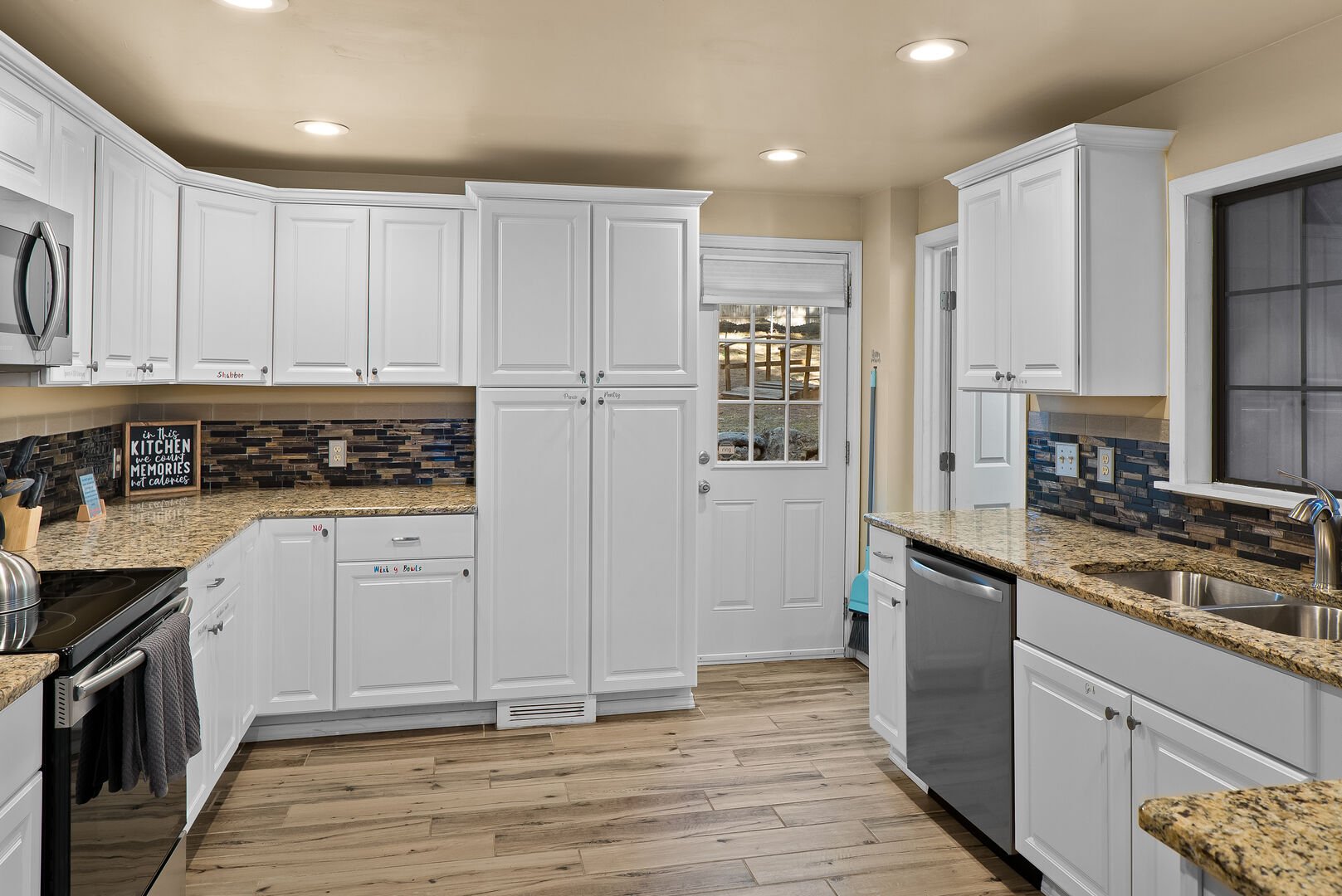 Spacious kitchen has all of the necessities to cook. Door leads to backyard.
