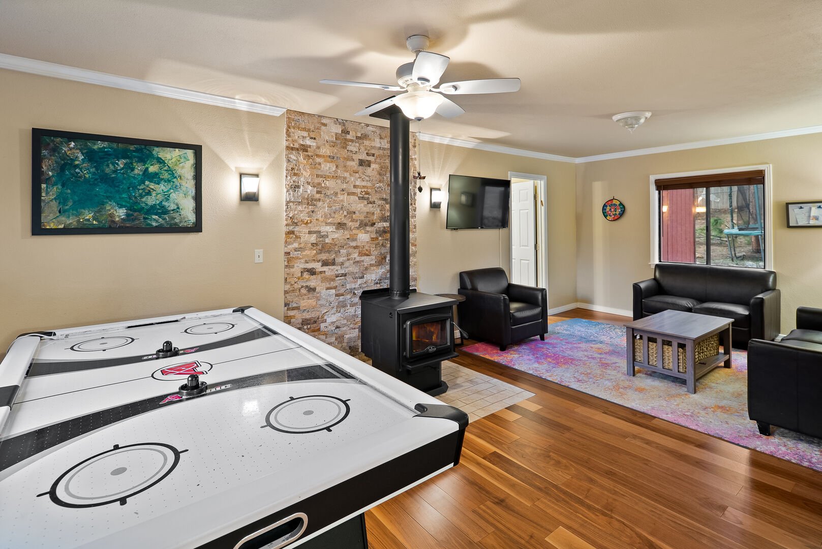 Living room offers a fireplace and hockey table.