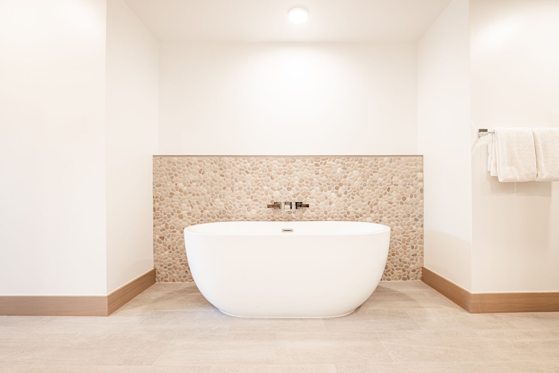 Large soaker tub with beautiful rock backdrop