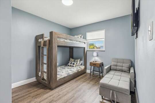Guest bedroom with twin bunk beds and fold out bed