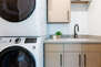 Upper level laundry room with washer/dryer units and sink