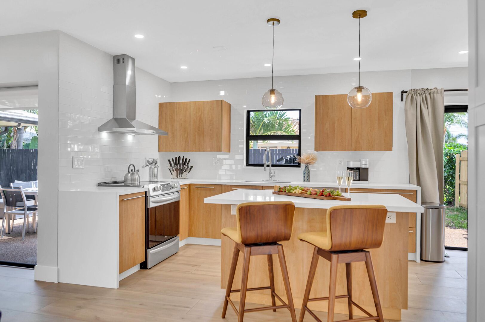 The kitchen comes with sleek countertops, modern appliances and bar seating for two people.